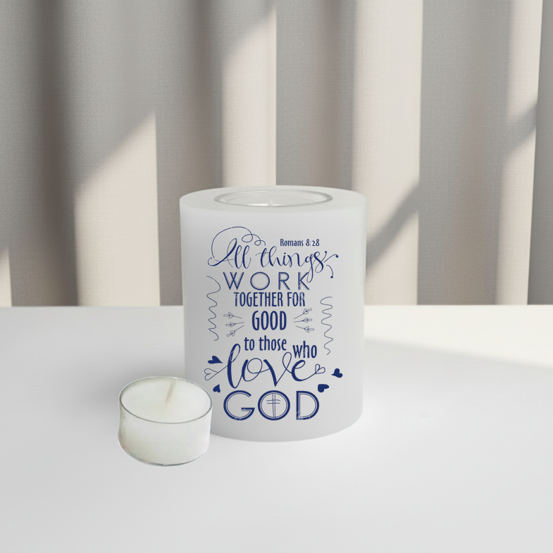 white candle with blue text against a neutral background