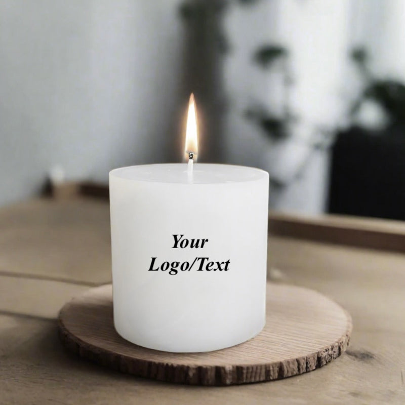 White candle with 'Your Logo/Text' on a wooden coaster with a blurred background