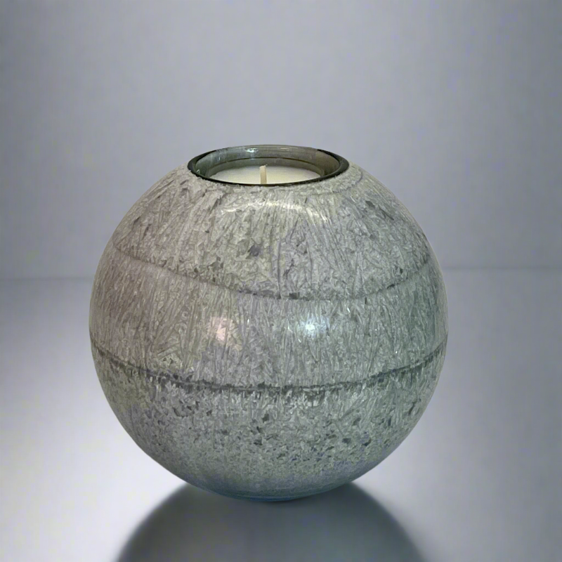 A grey crystal wax ball candle with a built-in glass holder to place a tealight or flameless LED tealight