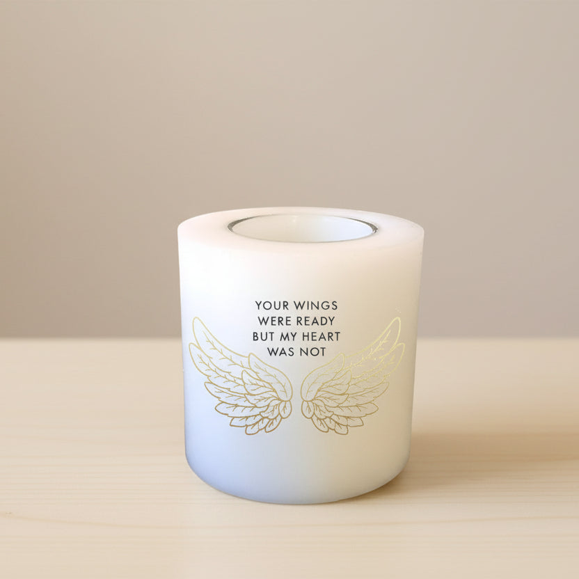 Candle with wings and text on a white background