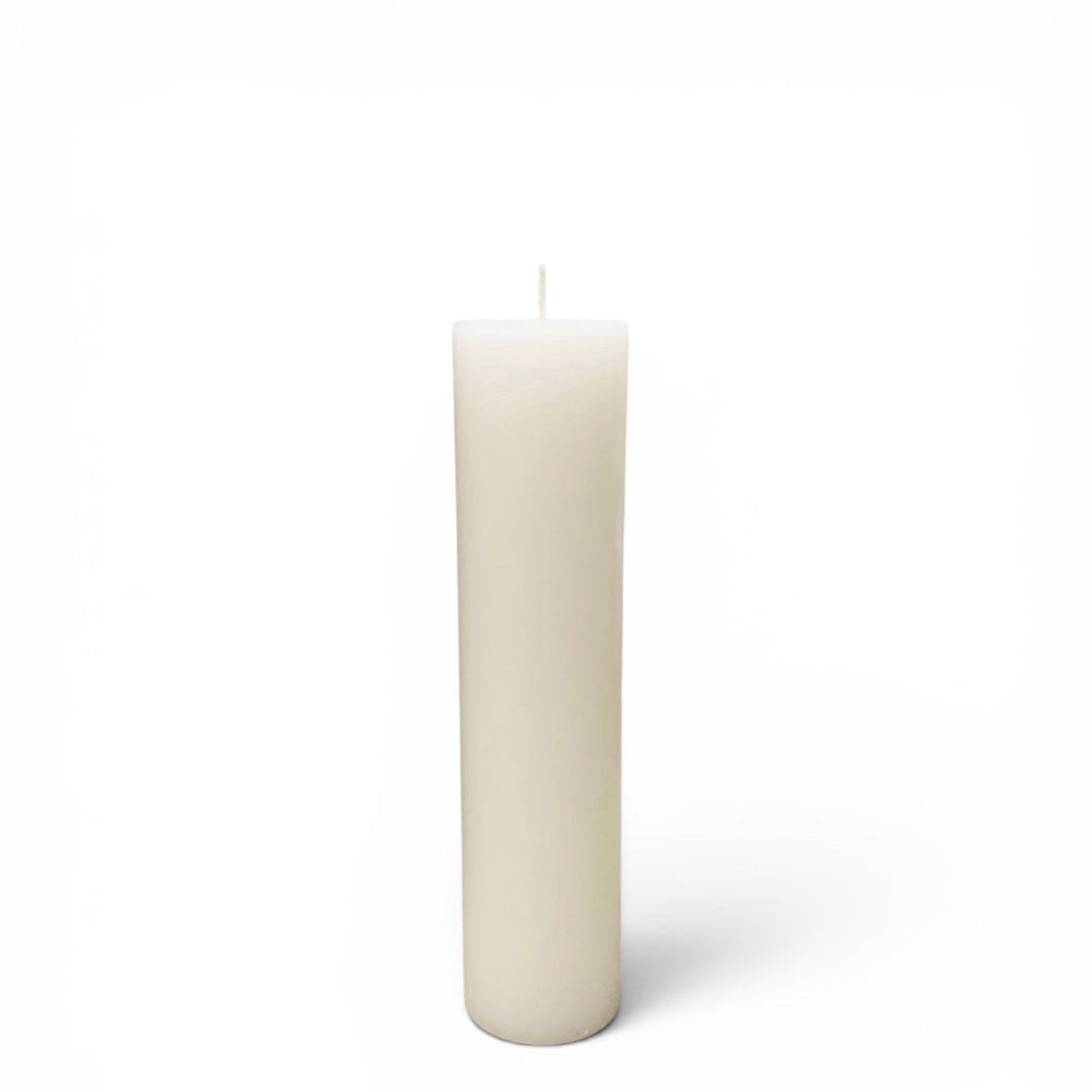 A single white pillar candle with a wick, standing upright against a clean white background.