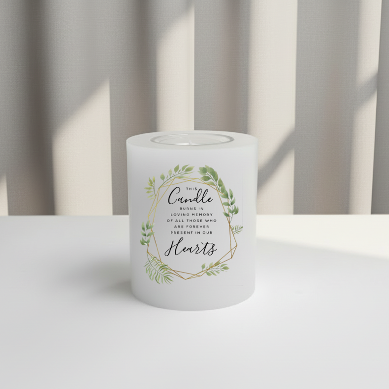 White everlasting candle with text and greenery design on a white surface with a striped background