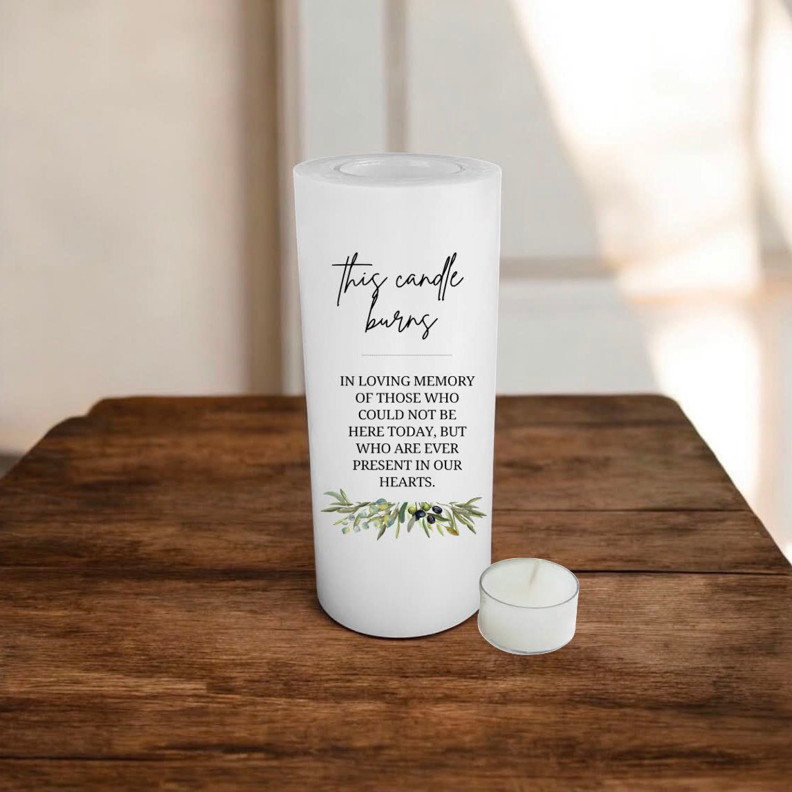 white candle with text on a wooden surface