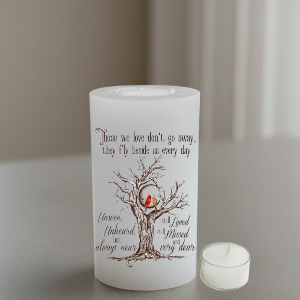 everlasting candle with a tree and birds design and text on a neutral background