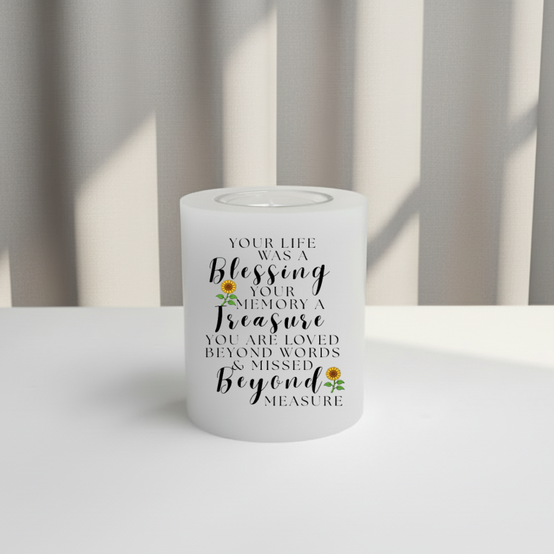memory candle with text and sunflower design on a white surface