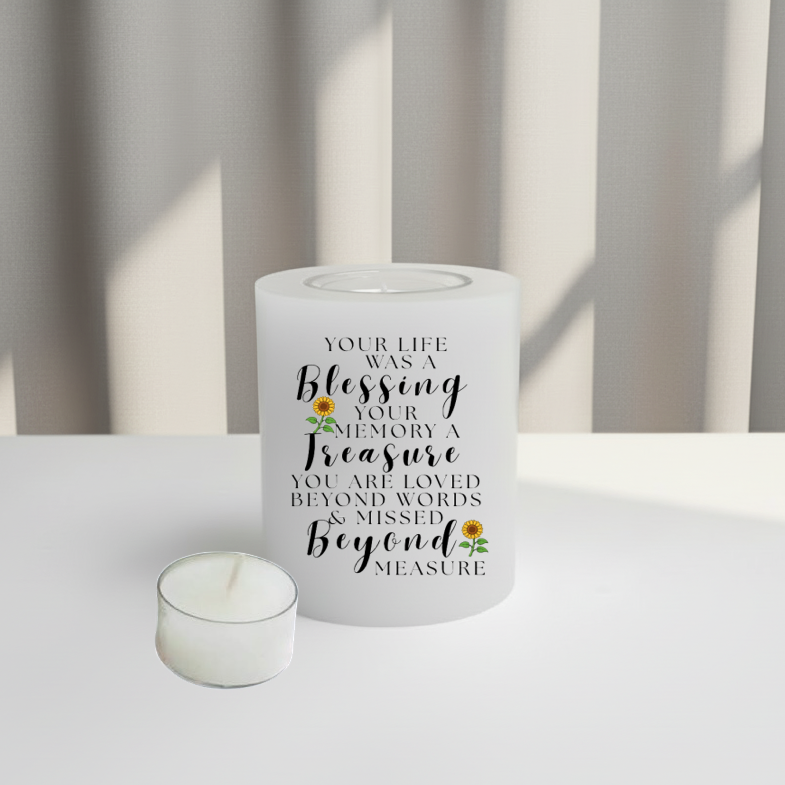 memory candle with text and sunflower design on a white surface