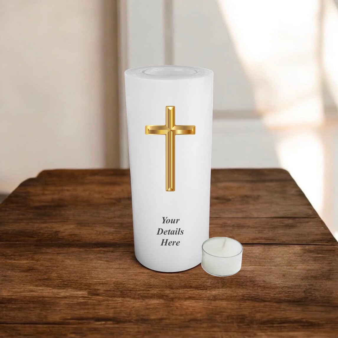 A white candle with gold cross on a wooden surface.