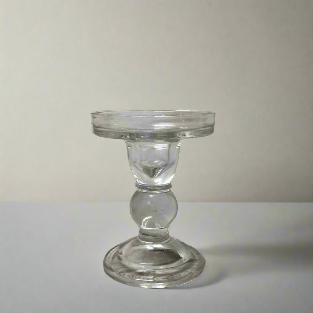 Clear glass candle holder on a wooden surface