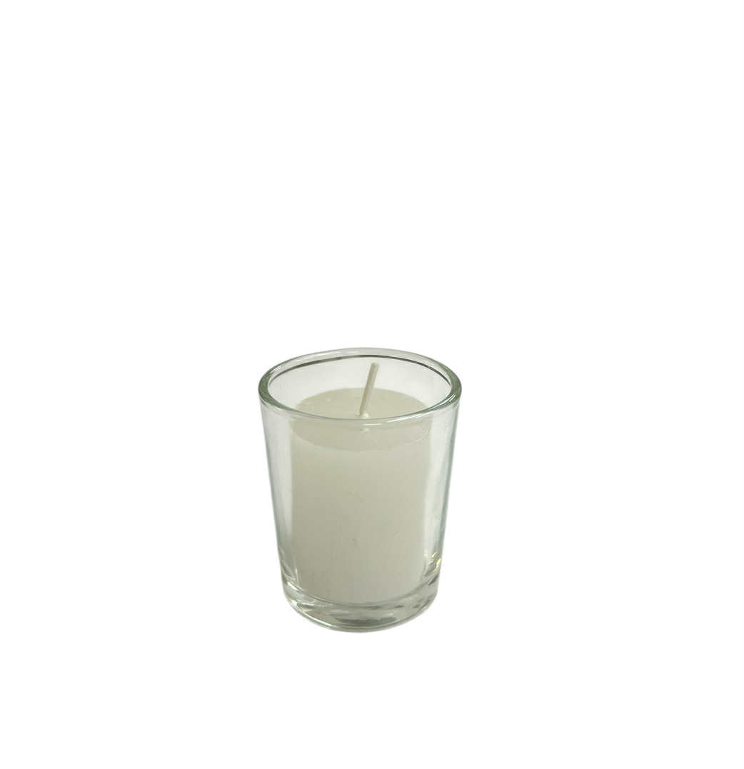 Clear votive glass candle holder with a white candle on a white background
