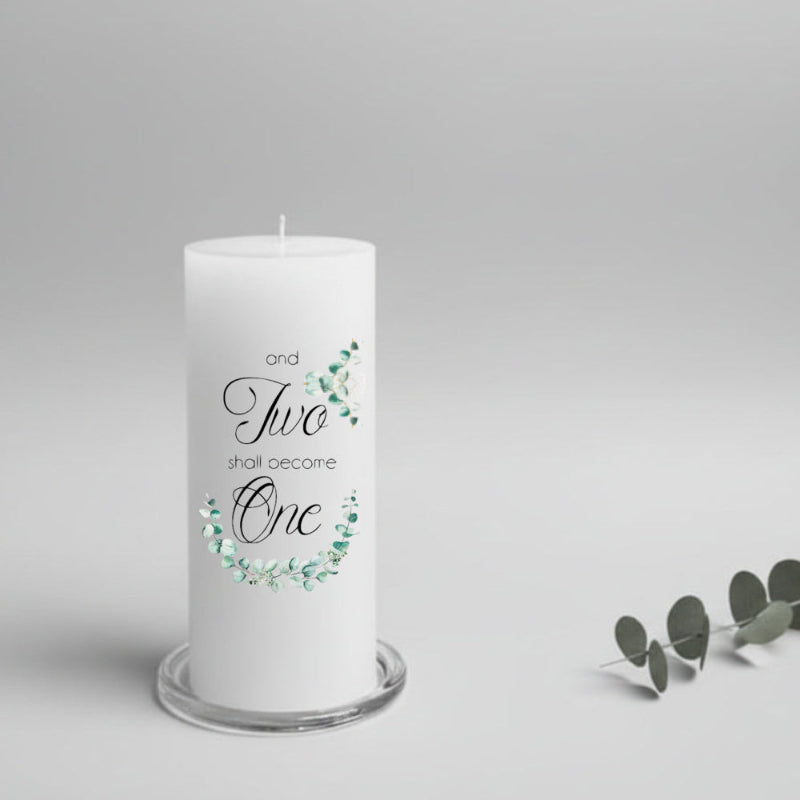 White wedding candle with decorative text and eucalyptus design on a gray background