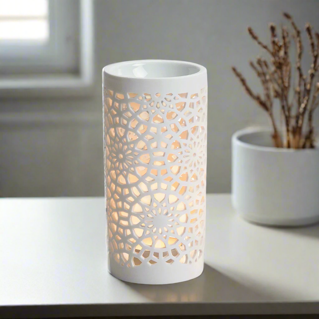 White decorative lamp with intricate cut-out pattern on a white background