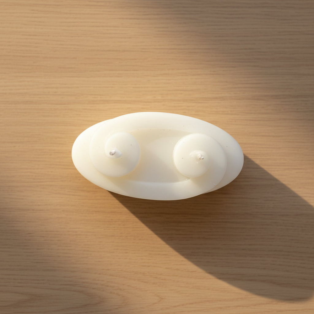 Round white object with two smaller spheres on a white background