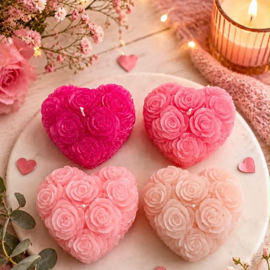 4 roes pink heart shaped candles with roses on a plate