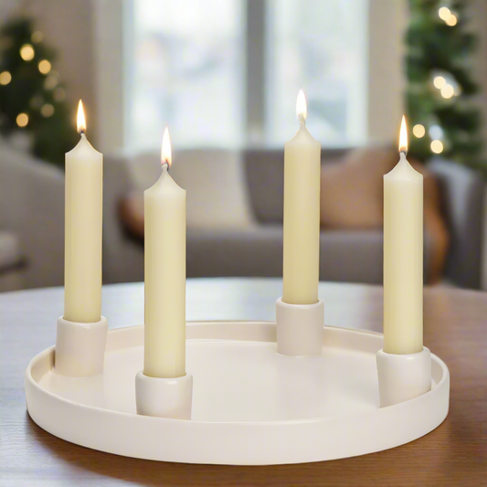 Advent Candle plate holder with four dinner candles on a white background