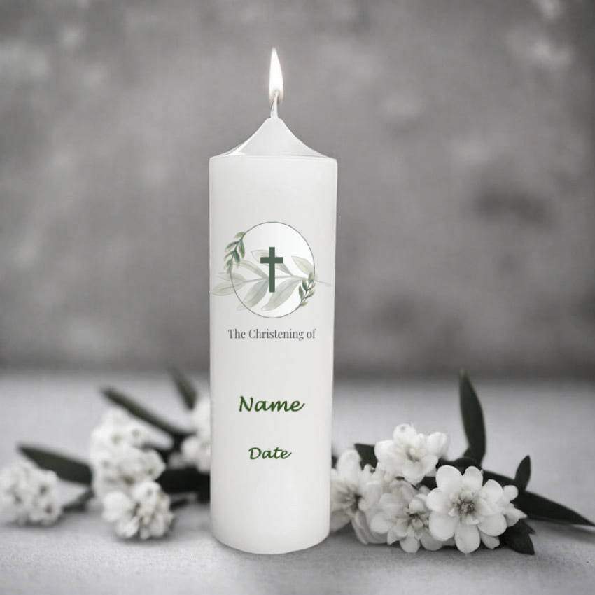 White candle with print and a flame surrounded by white flowers on a grey background