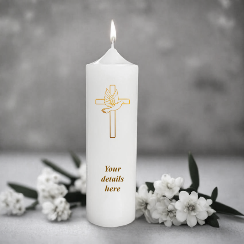 White candle with a gold cross design and dove.