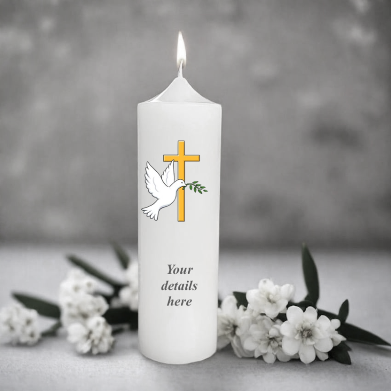 White christening candle with a cross and dove design, surrounded by white flowers on a gray background