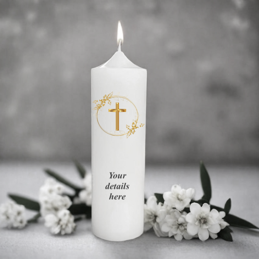 White candle with a cross symbol and floral wreath, surrounded by white flowers on a gray background