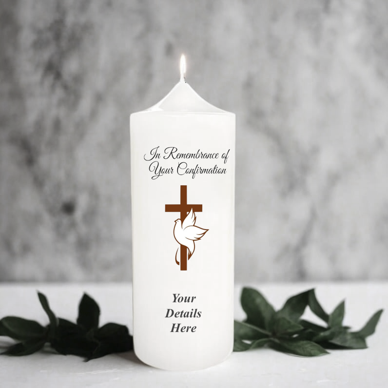 White candle with religious design and text on a gray background