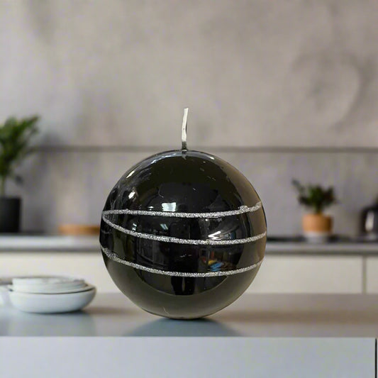 Black glittery ball candle on a desk in a modern kitchen