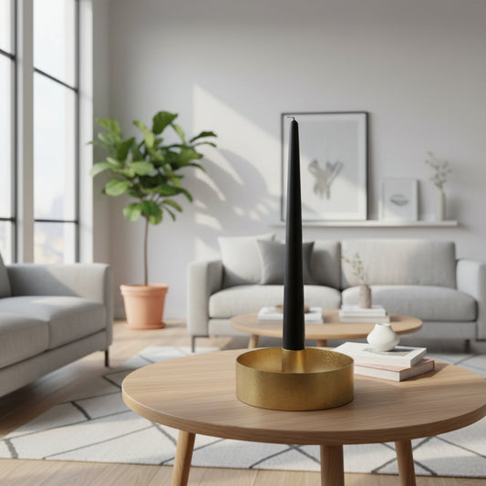 Brass candle holder with black candle on table in a living room