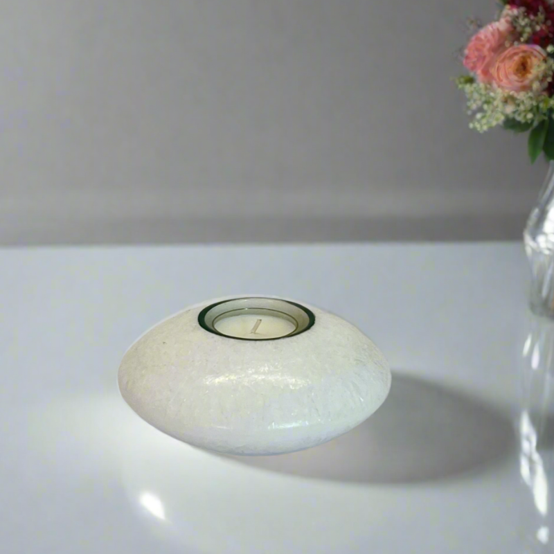 A white crystal wax discus candle with a built-in glass holder to place a tealight or flameless LED tealight 
