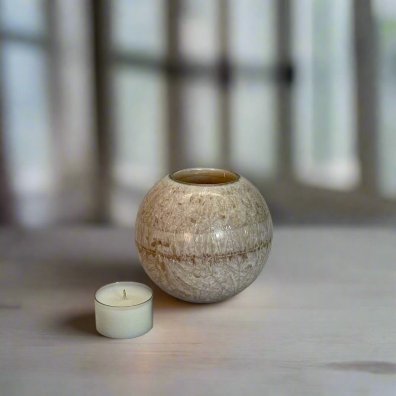 Crystal wax ball candle on sand colour with a built-in glass holder to place a tealight or flameless LED tealight 