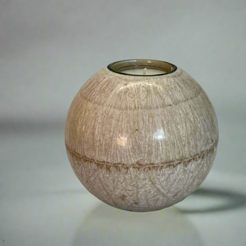 A crystal wax ball candle on sand colour with a built-in glass holder to place a tealight or flameless LED tealight 