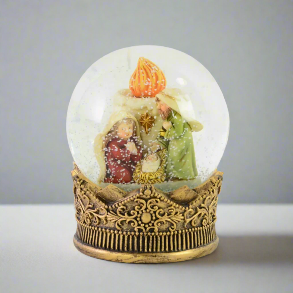 Decorative snow globe with nativity scene inside on a white background