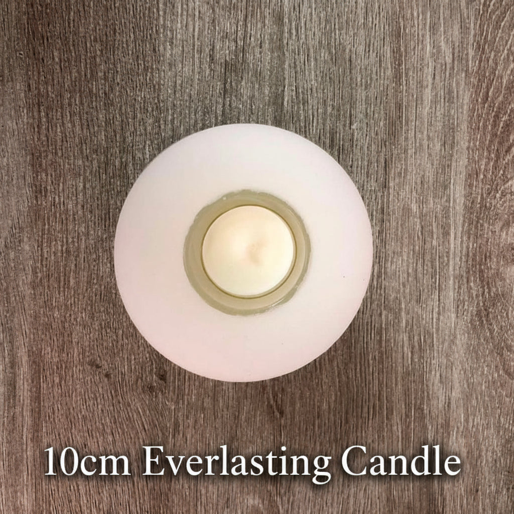 White everlasting denga candle with a burning cup inside on a wooden surface