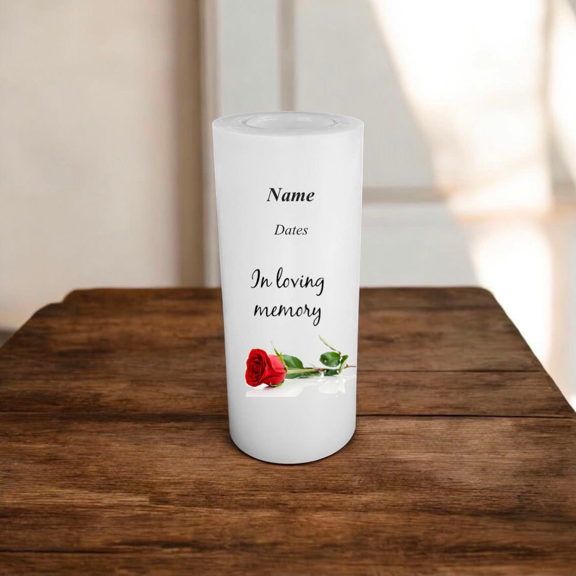 white memory candle on a wooden surface with text and a rose.