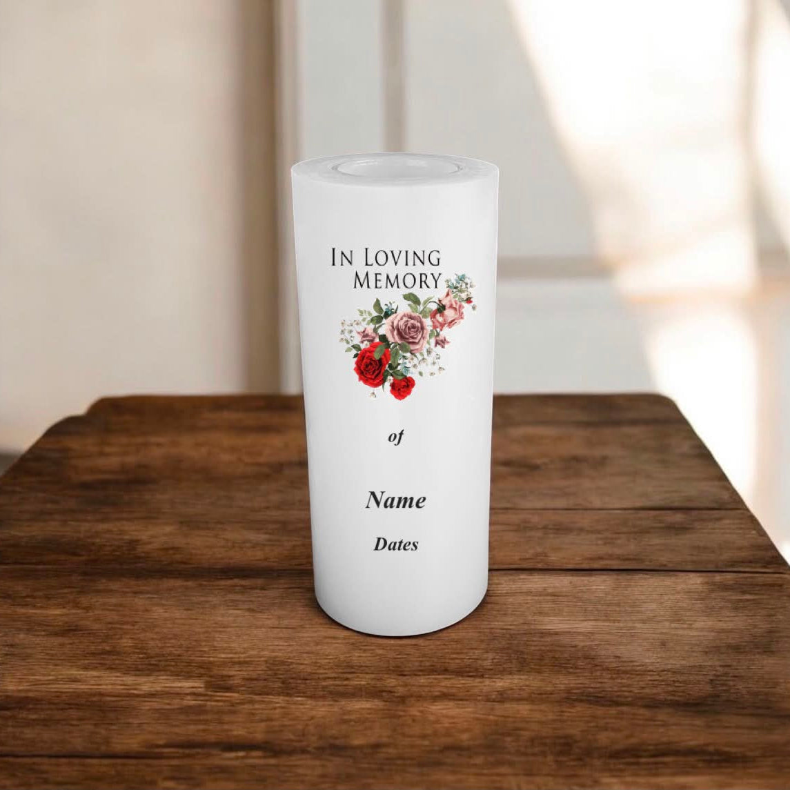 A white memorial candle standing on a wooden table, printed with the words 'IN LOVING MEMORY of Name Dates' and a small floral illustration.