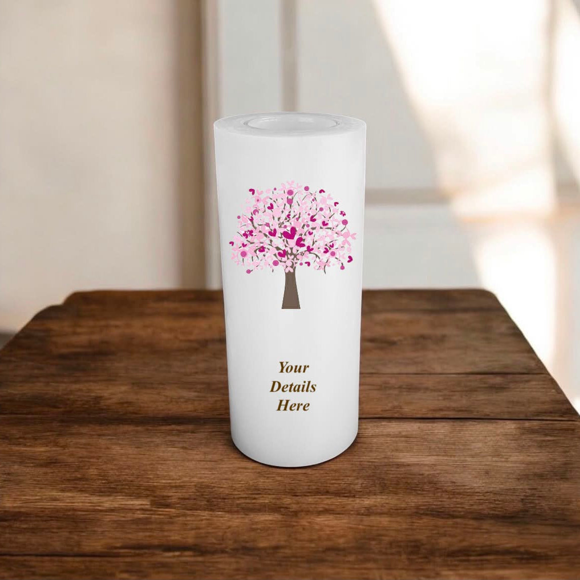 Personalized candle with a pink tree design on a wooden surface