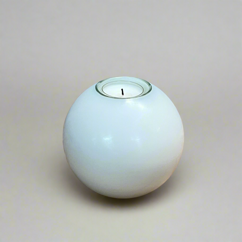 A white ball candle with a built-in glass holder to place a tealight or a flameless LED tealight.