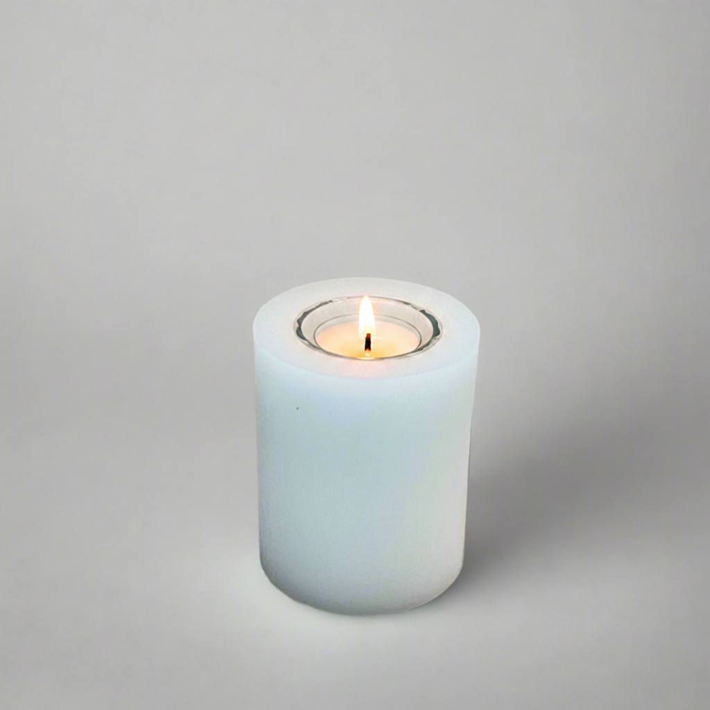 A white pillar candle with a built-in glass holder to place a tealight or a flameless LED tealight.
