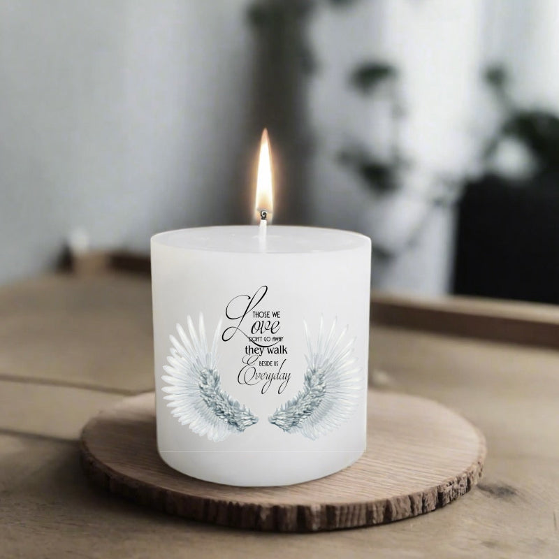 white candle with print on a wooden coaster