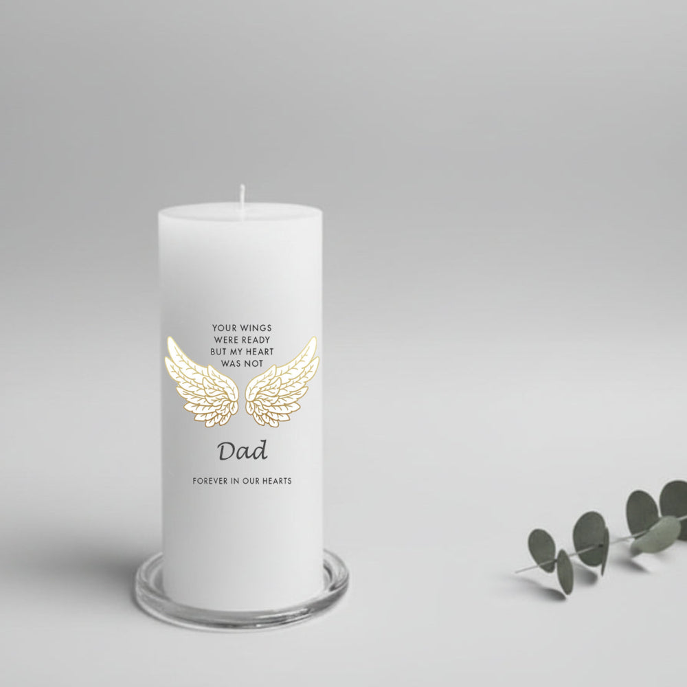 white candle with a text about Dad and wings on a glass plate holder