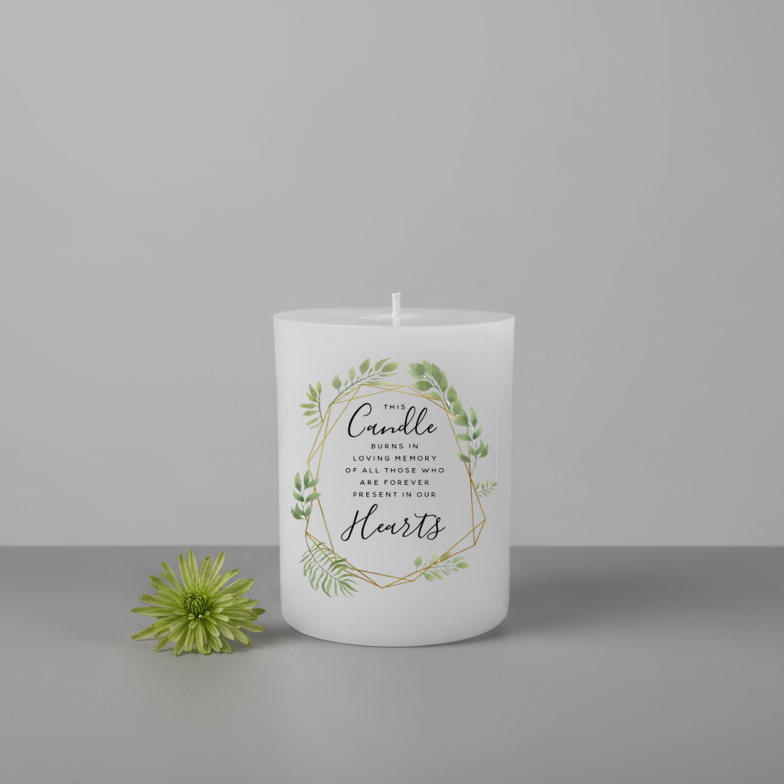 White printed candle with greenery and text on a grey background