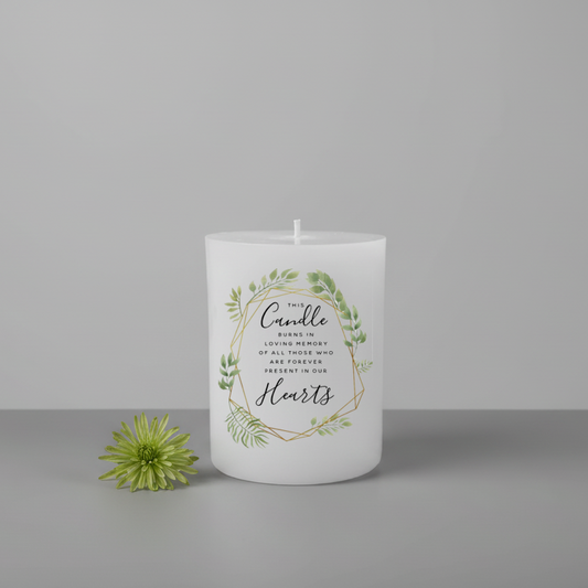 White printed candle with greenery and text on a grey background
