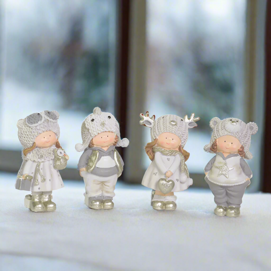 Four small figurines in winter clothing 
