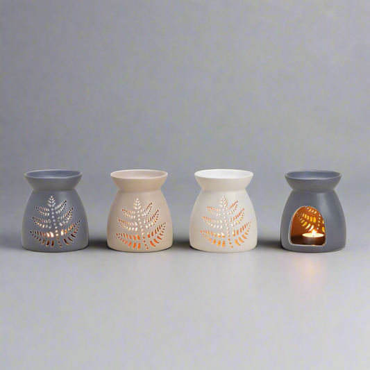 Four ceramic wax warmers with leaf designs 