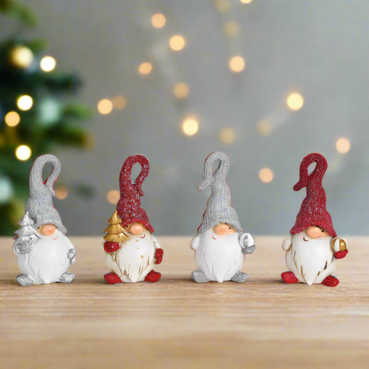 Four small gnome figurines with red and gray pointed hats on a white background