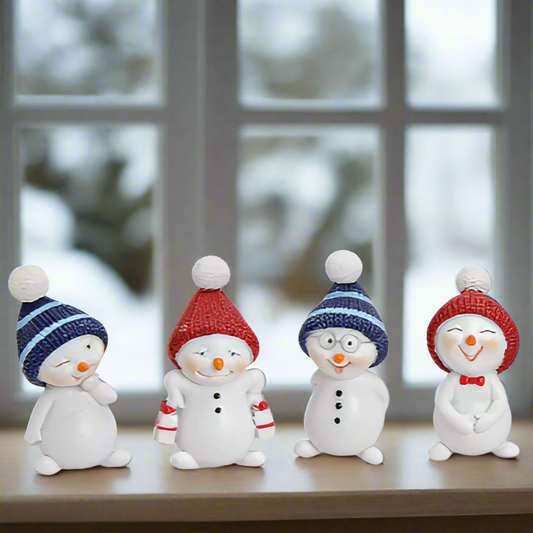 Four snowman figurines with colorful hats on a white background
