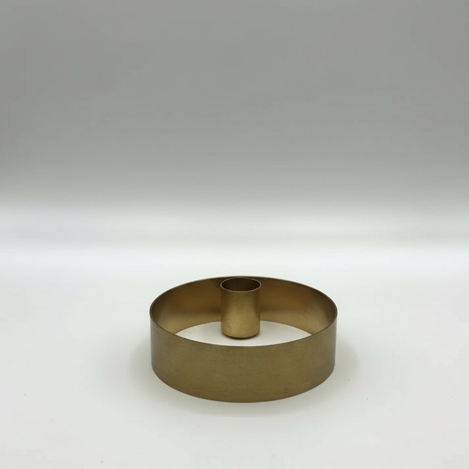 Brass ring on a white surface with a blurred background