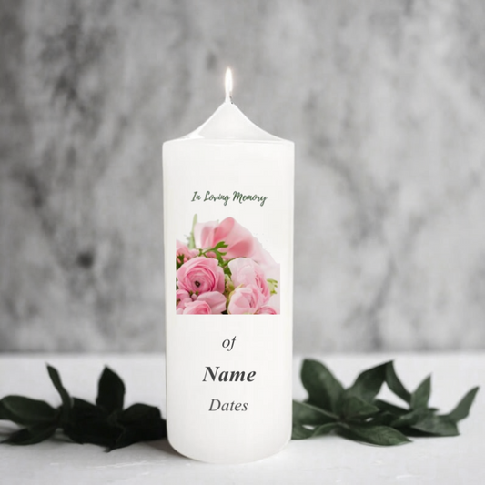 White memory candle with floral design and text on a gray background