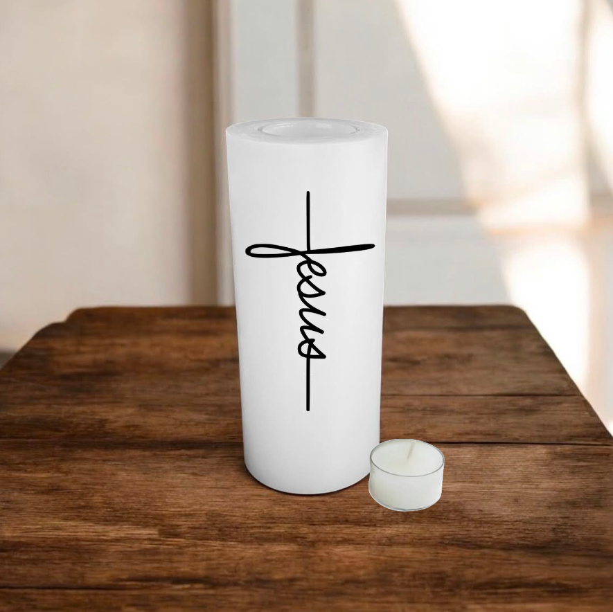 A white candle of size 8x19cm, printed Jesus, placed on a wooden surface