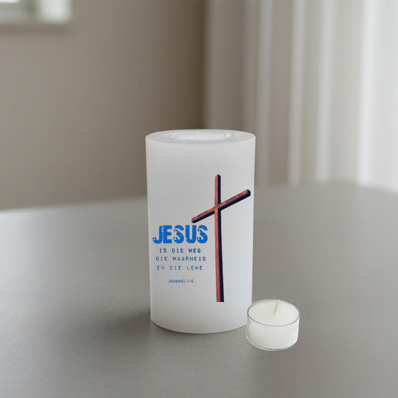 White candle with a cross and Afrikaans text on a neutral background