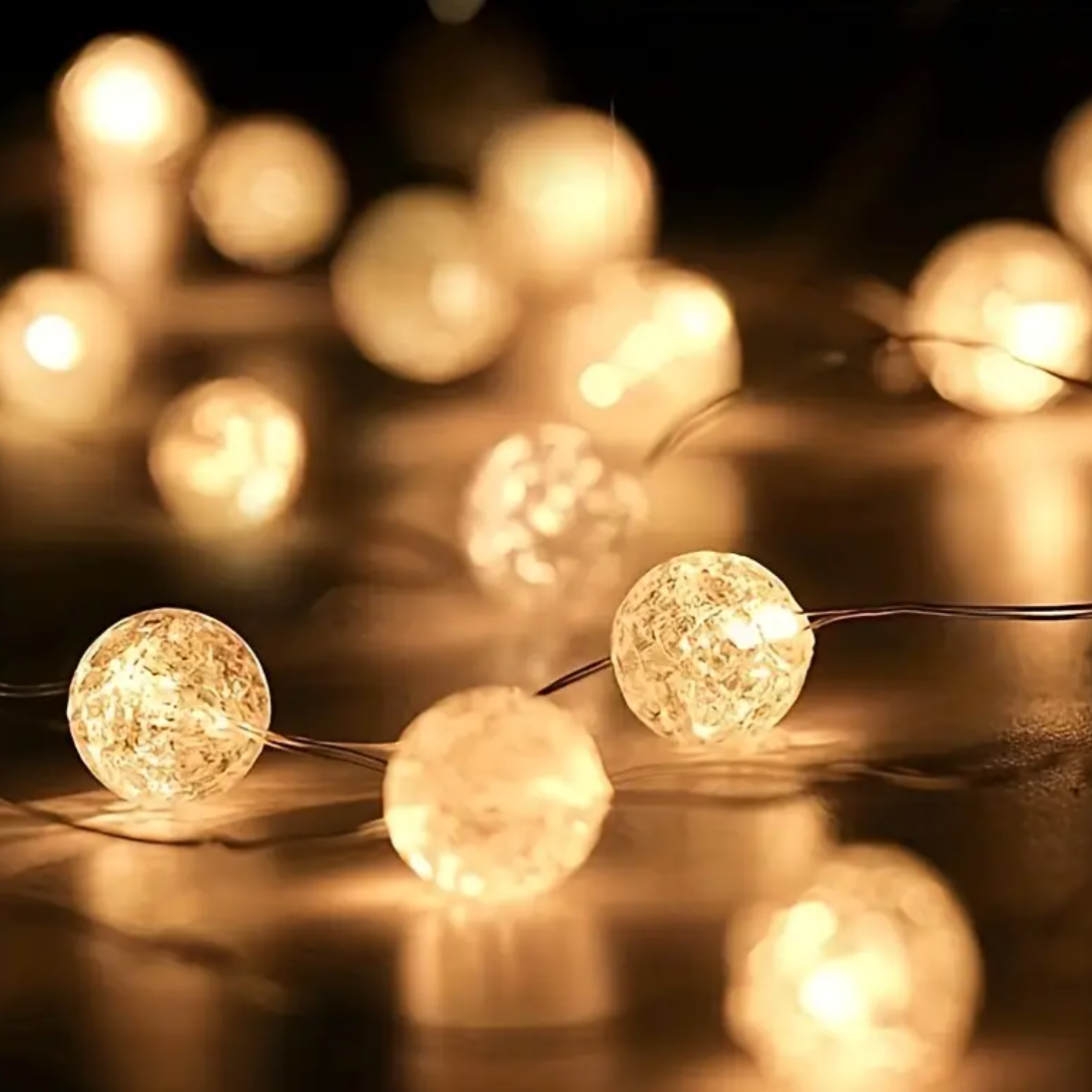 String of decorative lights with a warm glow on a dark background