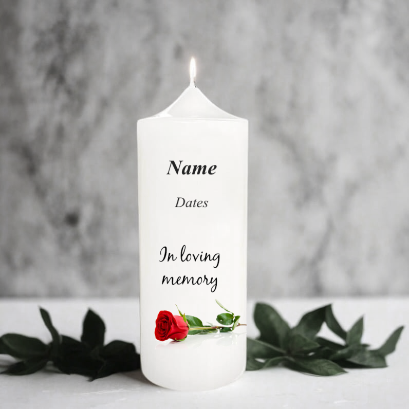 White memory candle with text and a red rose on a grey background