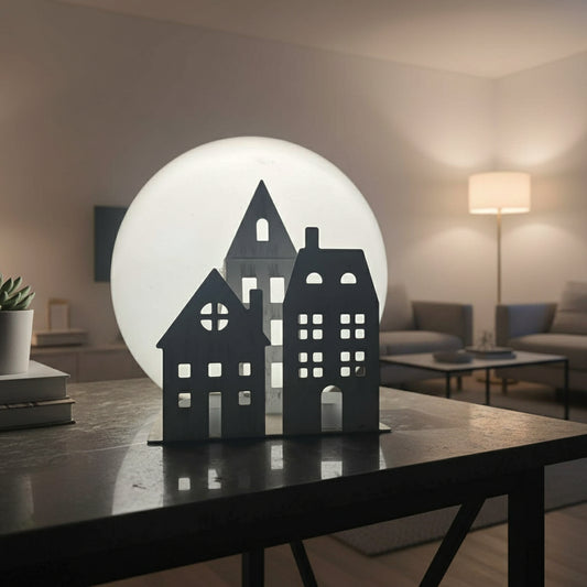Black silhouette of a house with a full moon in the background
